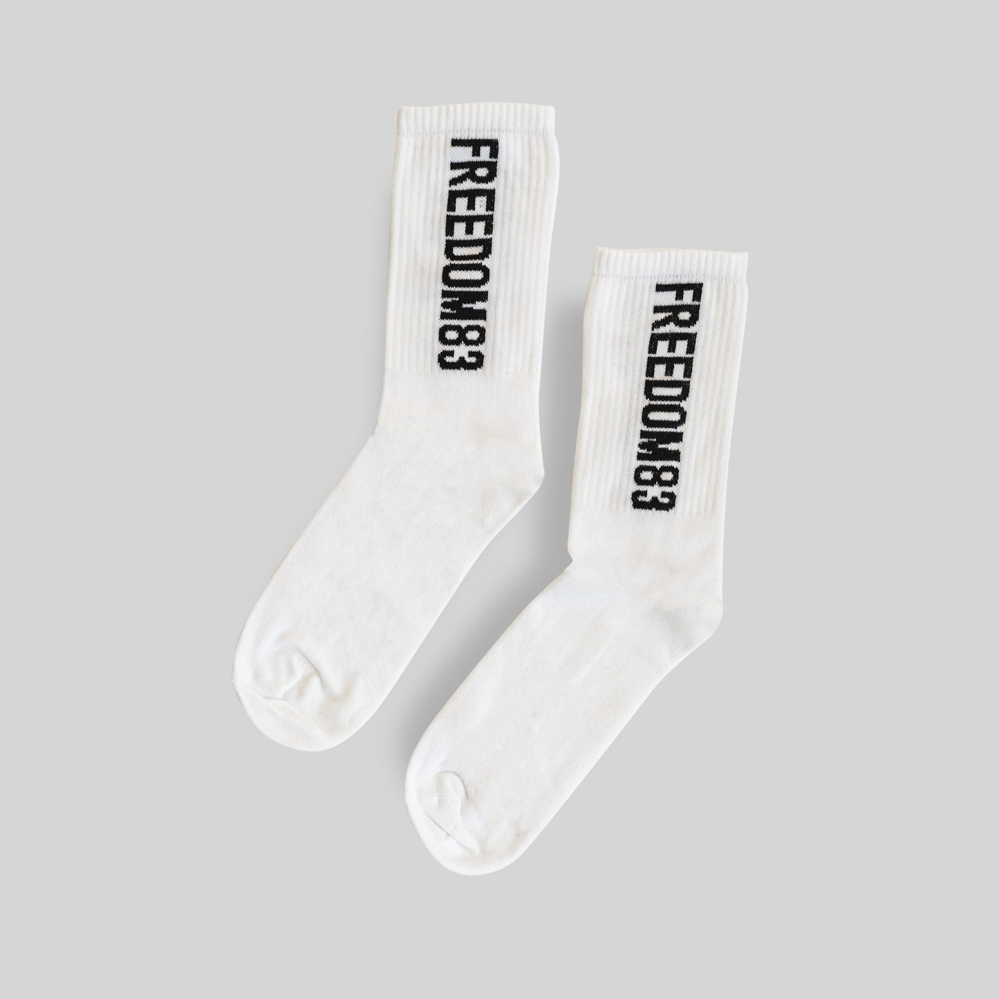 F83 Crew Socks White — Freedom 83 logo crew sock pair